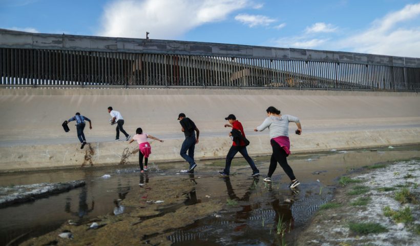 CIUDAD JUAREZ, MEXICO - MAY 19: Migrants cross the border between the U.S. and Mexico at the Rio Grande river, as they enter El Paso, Texas, on May 19, 2019 as taken from Ciudad Juarez, Mexico. The location is in an area where migrants frequently turn themselves in and ask for asylum in the U.S. after crossing the border. Approximately 1,000 migrants per day are being released by authorities in the El Paso sector of the U.S.-Mexico border amidst a surge in asylum seekers arriving at the Southern border. (Photo by Mario Tama/Getty Images)