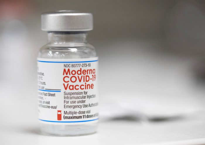 FILE - A vial of the Moderna COVID-19 vaccine is displayed on a counter at a pharmacy in Portland, Ore. on Dec. 27, 2021. A government advisory panel met Tuesday, June 14, 2022, to decide whether to recommend a second brand of COVID-19 vaccine for school-age children and teens. The Food and Drug Administration's outside experts will vote on whether Moderna's vaccine is safe and effective enough to give kids ages 6 to 17. If the panel endorses the shot and the FDA agrees, it would become the second option for those children, joining Pfizer's vaccine.(AP Photo/Jenny Kane, File)