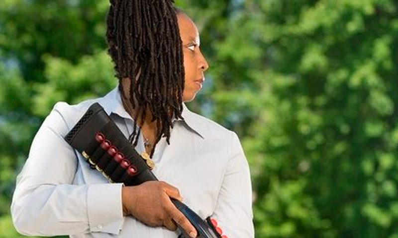 Image of Rhonda Ezell, the founder of the organization Chicago Guns Matter, holding a shotgun. Photo via chicagogunsmatter.org