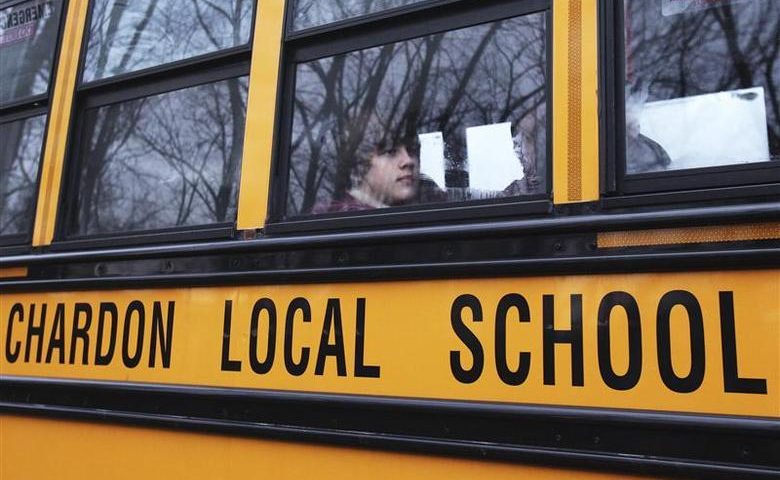 Students are seen on a Chardon Local School District bus arriving for the first day of regular schedule classes since the school shootings in Chardon, Ohio March 2, 2012. Three students were killed and two others wounded by suspect T.J. Lane in Monday's shooting rampage at the Ohio high school. REUTERS/Shannon Stapleton