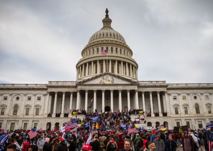 WASHINGTON, DC - JANUARY 06: A large group of pro-Trump protesters stand on the East steps of the Capitol Building after storming its grounds on January 6, 2021 in Washington, DC. A pro-Trump mob stormed the Capitol, breaking windows and clashing with police officers. Trump supporters gathered in the nation's capital today to protest the ratification of President-elect Joe Biden's Electoral College victory over President Trump in the 2020 election. (Photo by Jon Cherry/Getty Images)