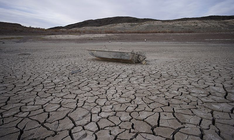 FILE - A formerly sunken boat sits on cracked earth hundreds of feet from the shoreline of Lake Mead at the Lake Mead National Recreation Area on May 10, 2022, near Boulder City, Nev. Another body has surfaced at Lake Mead, this time in a swimming area where water levels have dropped as the Colorado River reservoir behind Hoover Dam recedes due to drought and climate change. The National Park Service did not say in a statement how long officials think the corpse was submerged in the Boulder Beach area before it was found Monday, July 25, 2022, by people who summoned park rangers. (AP Photo/John Locher, File)