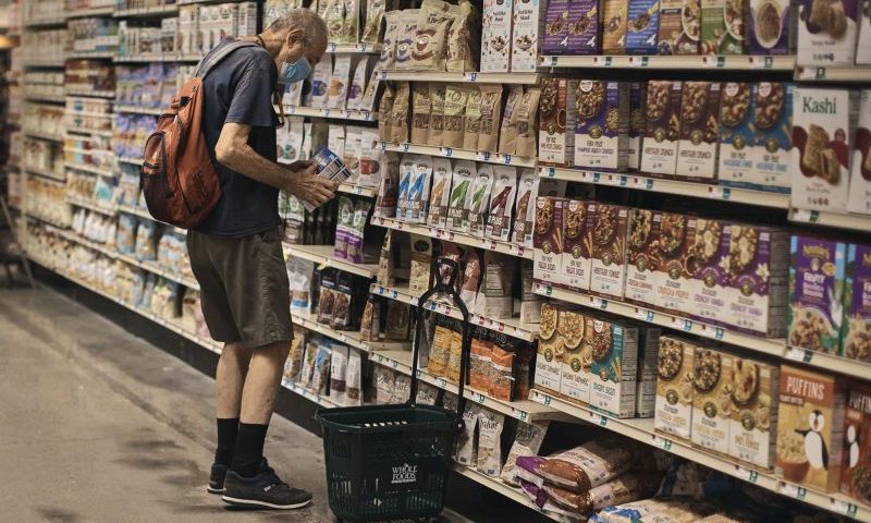 A man shops at a supermarket on Wednesday, July 27, 2022, in New York. The U.S. economy shrank from April through June for a second straight quarter, contracting at a 0.9% annual pace and raising fears that the nation may be approaching a recession. (AP Photo/Andres Kudacki)