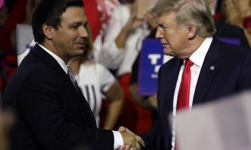 Gov. Ron DeSantis, left, shakes hand with President Trump, right, at the Florida Fairgrounds. (AP Photo)