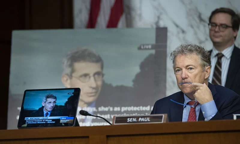 Sen. Rand Paul, R-Ky, questions Anthony Fauci, Director, National Institute of Allergy and Infectious Diseases, National Institutes of Health, while displaying a video and poster of Fauci, during the Senate Health, Education, Labor, and Pensions hearing to examine stopping the spread of monkeypox, focusing on the Federal response, in Washington, Wednesday, Sept. 14, 2022. (AP Photo/Cliff Owen)