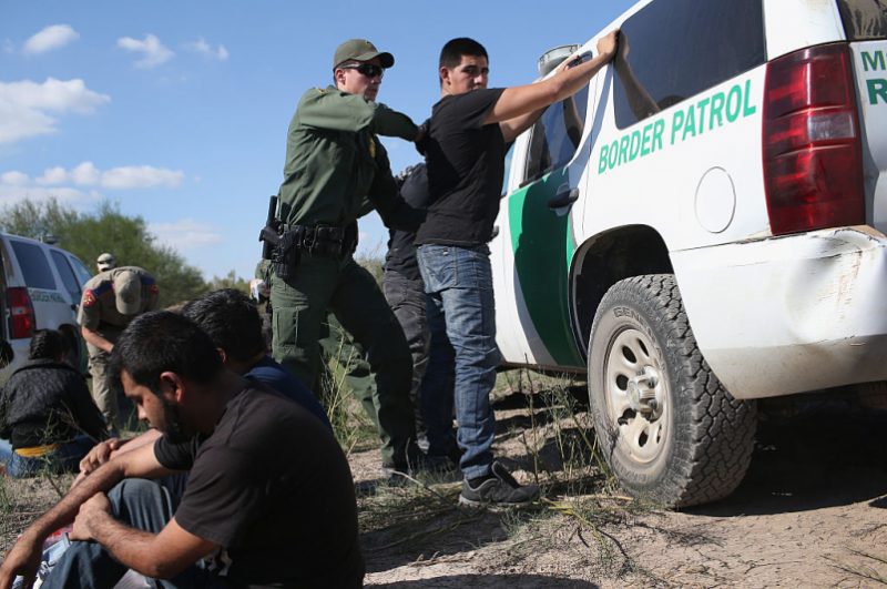 RIO GRANDE CITY, TX - DECEMBER 07: A U.S. Border Patrol officer body searches an undocumented immigrant after he illegally crossed the U.S.-Mexico border and was caught on December 7, 2015 near Rio Grande City, Texas. Border Patrol agents continue to detain hundreds of thousands of undocumented immigrants trying to avoid capture after crossing into the United States, even as migrant families and unaccompanied minors from Central America cross and turn themselves in to seek assylum. (Photo by John Moore/Getty Images)