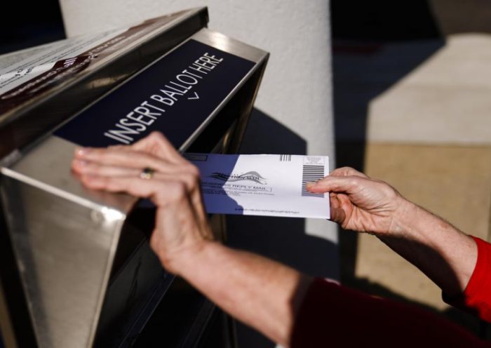 A person drops off a mail-in ballot at an election ballot return box in Willow Grove, Pa., Oct. 25, 2021. On Tuesday, May 3, 2022, The Associated Press reported on a film that used a flawed analysis of cellphone location data and ballot drop box surveillance footage to cast doubt on the results of the 2020 presidential election. (AP Photo/Matt Rourke)