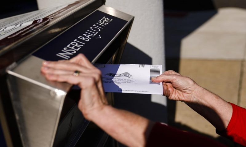 A person drops off a mail-in ballot at an election ballot return box in Willow Grove, Pa., Oct. 25, 2021. On Tuesday, May 3, 2022, The Associated Press reported on a film that used a flawed analysis of cellphone location data and ballot drop box surveillance footage to cast doubt on the results of the 2020 presidential election. (AP Photo/Matt Rourke)