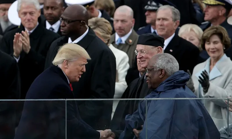 WASHINGTON, DC - JANUARY 20: President Donald Trump shakes hands with Supreme Court Justice Clarence Thomas on the West Front of the U.S. Capitol on January 20, 2017 in Washington, DC. In today's inauguration ceremony Donald J. Trump becomes the 45th president of the United States. (Photo by Alex Wong/Getty Images)