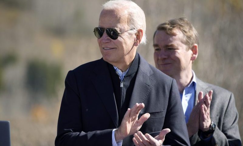 President Joe Biden applauds before designating the first national monument of his administration at Camp Hale, a World War II era training site, Wednesday, Oct. 12, 2022, near Leadville, Colo. U.S. Sen. Michael Bennet, D-Colo., looks on. (AP Photo/David Zalubowski)