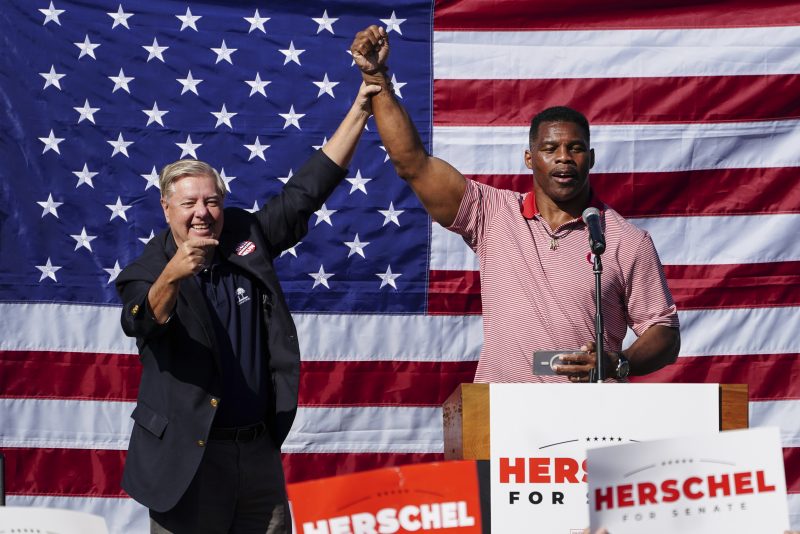 Herschel Walker, right, Republican candidate for U.S. Senate in Georgia, poses with Sen. Lindsey Graham, R-S.C. after speaking during a campaign stop in Cumming, Ga., Thursday, Oct. 27, 2022. (AP Photo/John Bazemore)
