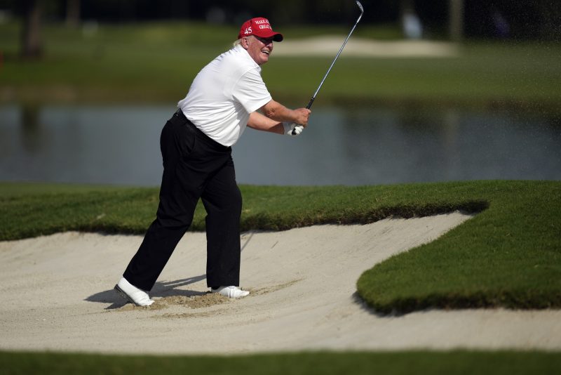 Former President Donald Trump watches his shot as he hits out of a greenside bunker on the eighth hole, during the pro-am ahead of the LIV Golf Team Championship, Thursday, Oct. 27, 2022, at Trump National Doral Golf Club in Doral, Fla. (AP Photo/Rebecca Blackwell)