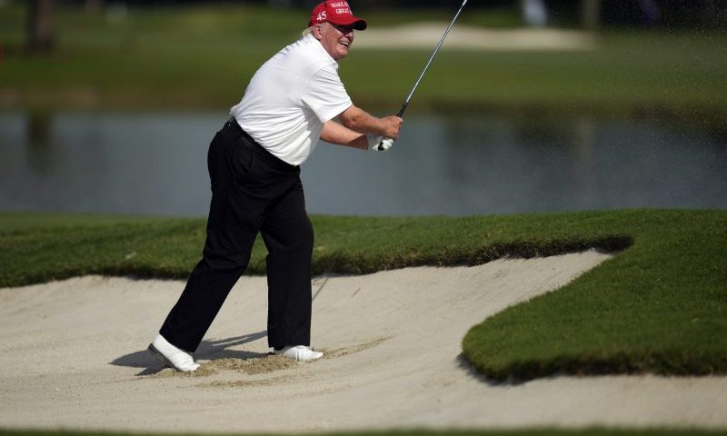 Former President Donald Trump watches his shot as he hits out of a greenside bunker on the eighth hole, during the pro-am ahead of the LIV Golf Team Championship, Thursday, Oct. 27, 2022, at Trump National Doral Golf Club in Doral, Fla. (AP Photo/Rebecca Blackwell)