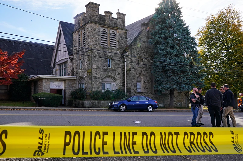 Police investigate the scene outside the Destiny of Faith Church in Pittsburgh, Friday Oct. 28, 2022, where a shooting while a funeral was being held, left six wounded, inclusing one person who was in critical condition. (Gene J. Puskar/ AP)