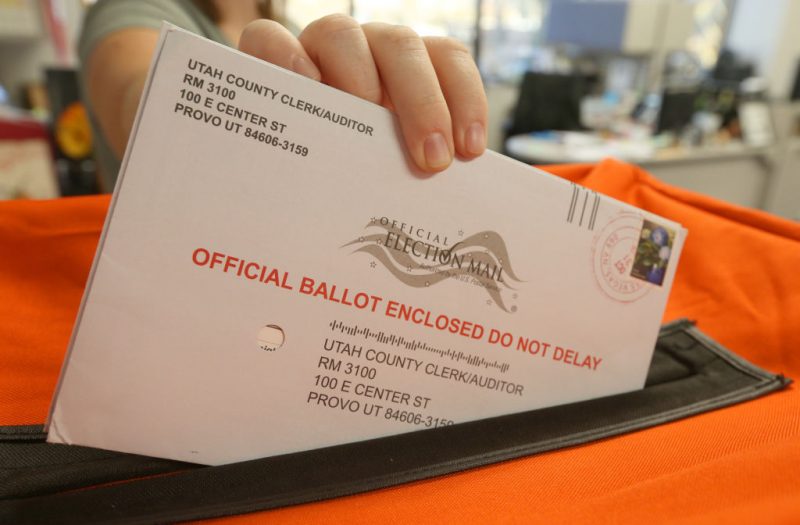 PROVO, UT - November 6: A employee at the Utah County Election office puts mail in ballots into a container to register the vote in the midterm elections on November 6, 2018 in Provo, Utah. Utah early voting has been the highest ever in Utah's midterm elections. One of the main proportions on the ballot in Utah is whether Utah will legalize medical marijuana. (Photo by George Frey/Getty Images)
