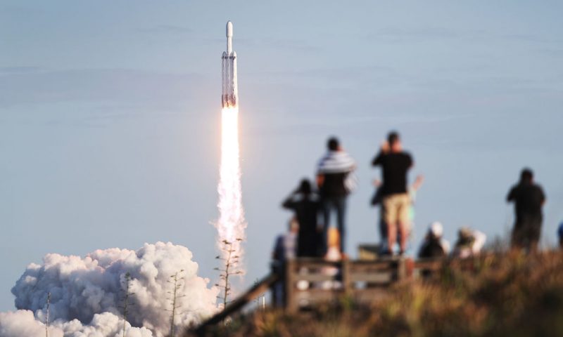 TITUSVILLE, FLORIDA - APRIL 11: People watch as the SpaceX Falcon Heavy rocket lifts off from launch pad 39A at NASA’s Kennedy Space Center on April 11, 2019 in Titusville, Florida. The rocket is carrying a communications satellite built by Lockheed Martin into orbit. (Photo by Joe Raedle/Getty Images)