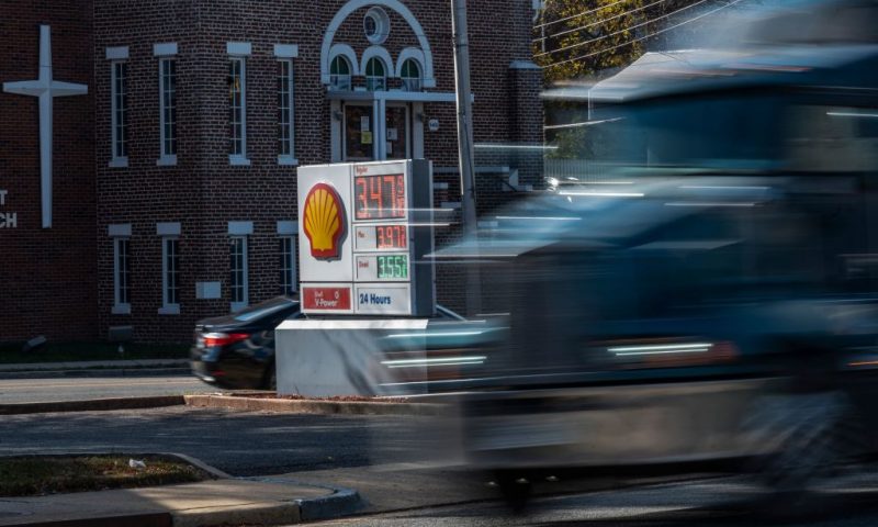 A semi truck drives past a price board at a Shell gas station near a church in Alexandria, Virginia on November 23, 2021. - With inflation surging ahead of the Thanksgiving holiday, US President Joe Biden has drawn on the seldom-used Strategic Petroleum Reserve to combat rising oil prices that have fueled the recent spike. (Photo by ANDREW CABALLERO-REYNOLDS / AFP) (Photo by ANDREW CABALLERO-REYNOLDS/AFP via Getty Images)