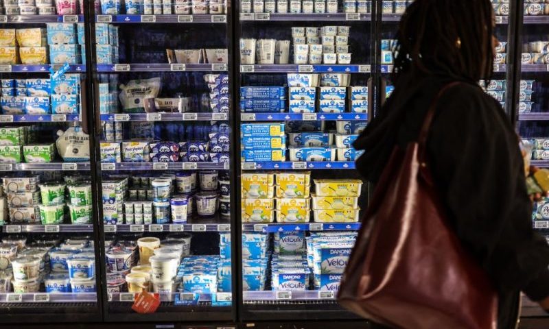 A woman walks past dairy products in a supermarket in Toulouse, southwestern France on October 12, 2022. (Photo by Charly TRIBALLEAU / AFP) (Photo by CHARLY TRIBALLEAU/AFP via Getty Images)