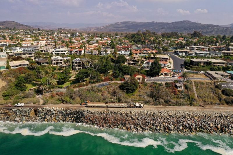 In this aerial view, train tracks follow along a coastline now devoid of all sand, near the exclusive Cyprus Shore residential community in San Clemente, California, on October 12, 2022. - In this southern California city, the ocean is inexorably gaining ground. In front of the railway dike where the "Pacific Surfliner" passes, this train renowned for its exceptional panorama, the beach that stretched over a hundred meters a few years ago has evaporated. (Photo by Robyn Beck / AFP) (Photo by ROBYN BECK/ AFP/AFP via Getty Images)