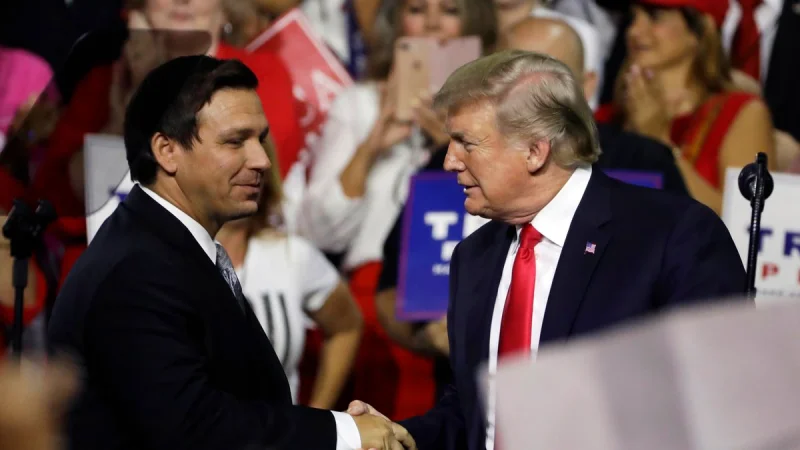 In this July 31, 2018, file photo, President Donald Trump, right, shakes hands with Florida Republican gubernatorial candidate Ron DeSantis during a rally in Tampa, Fla. Florida voters are going to the polls, Tuesday, Aug. 28, 2018, to select nominees to replace Republican Gov. Rick Scott in an election that’s caught the attention of Trump. (AP Photo/Chris O'Meara, File)(AP)