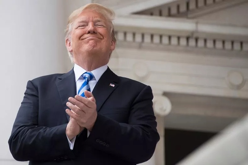 President Donald Trump applauds while speaking at a Memorial Day ceremony at Arlington National Cemetery in Virginia on May 28. (JIM WATSON/AFP/GETTY IMAGES)
