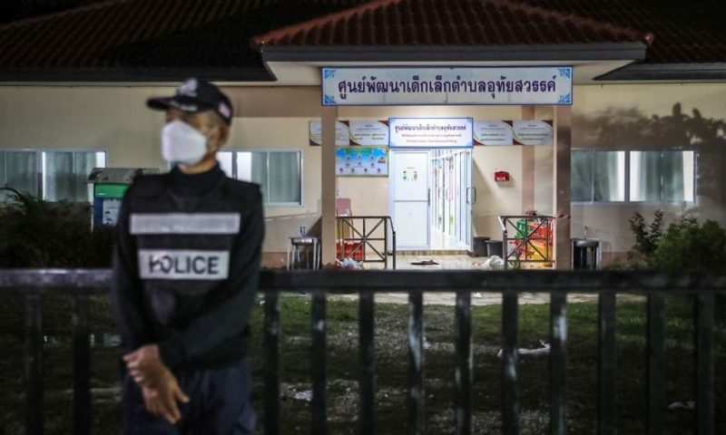 A policeman standing watch outside a day care center in Thailand following a mass shooting. LAUREN DECICCA / GETTY IMAGES