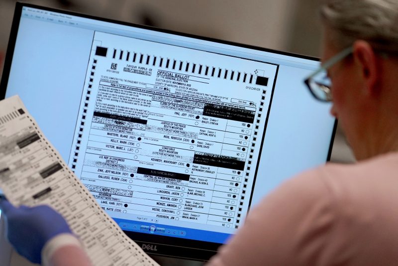 An election worker verifies a ballot on a screen inside the Maricopa County Recorders Office, Thursday, Nov. 10, 2022, in Phoenix. (AP Photo/Matt York)