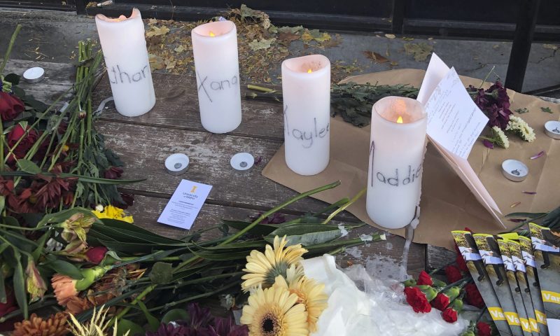 Candles and flowers are left at a make-shift memorial honoring four slain University of Idaho students outside the Mad Greek restaurant in downtown Moscow, Idaho, on Tuesday, Nov. 15, 2022. Police discovered the bodies of the four students at home near campus on Sunday, Nov. 13, 2022, and said the killer or killers used a knife or bladed weapon in the targeted attack. Two of the victims, 21-year-old Madison Mogen and 20-year-old Xana Kernodle, were servers at Mad Greek. (AP Photo/Nicholas K. Geranios)