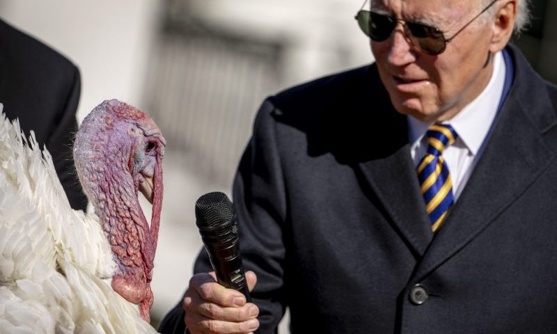 President Joe Biden holds the microphone to Chocolate, the national Thanksgiving turkey, during a pardoning ceremony at the White House in Washington, Monday, Nov. 21, 2022. (AP Photo/Andrew Harnik)