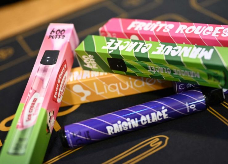 A picture shows boxes of "puffs" disposable electronic cigarettes displayed on table at La Vapotitheque store in Bethune, northern France, on May 25, 2022. - The "puffs" disposable electronic cigarettes, with their tangy or fruity flavours and a sold at around 8 and 12 euros at tobacconists, on websites or in supermarkets, are a hit with some teenagers, but worry doctors and health authorities. They come in a wide range of flavours and offer some 600 "puffs" for a nicotine level of between 0 and 20 mg/ml. (Photo by DENIS CHARLET / AFP) (Photo by DENIS CHARLET/AFP via Getty Images)