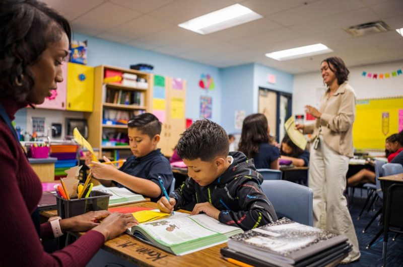 Aisha Thomas (L) learns teaching skills with teacher Alexxa Martinez, in her classroom in Nevitt Elementary School, in Phoenix, Arizona, on October 26, 2022. - Teachers in Arizona are among the United States' lowest paid, making the cost-of-living crisis even more acute for educators in this key battleground for the upcoming mid-term elections. (Photo by Olivier TOURON / AFP) (Photo by OLIVIER TOURON/AFP via Getty Images)