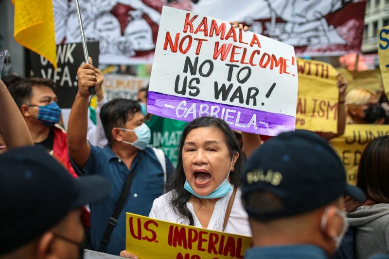 Protesters carry placards and shout slogans during a demonstration against the visit of US Vice President Kamala Harris in Manila on November 21, 2022. (Photo by Czar DANCEL / AFP) (Photo by CZAR DANCEL/AFP via Getty Images)