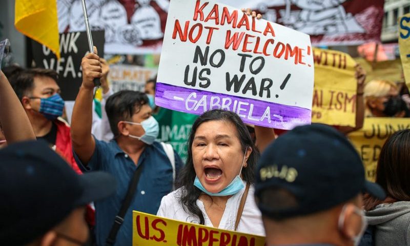 Protesters carry placards and shout slogans during a demonstration against the visit of US Vice President Kamala Harris in Manila on November 21, 2022. (Photo by Czar DANCEL / AFP) (Photo by CZAR DANCEL/AFP via Getty Images)