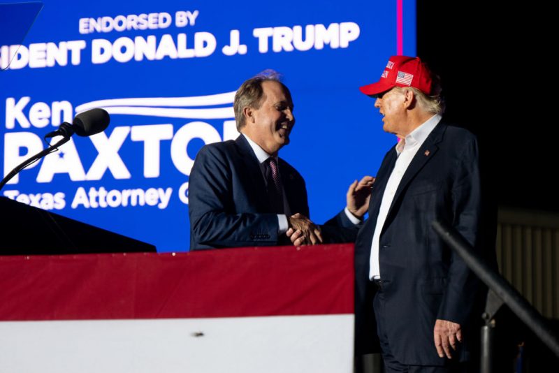 ROBSTOWN, TEXAS - OCTOBER 22: (L-R) Texas Attorney General Ken Paxton greets former U.S. President Donald Trump at the 'Save America' rally on October 22, 2022 in Robstown, Texas. The former president, alongside other Republican nominees and leaders held a rally where they energized supporters and voters ahead of the midterm election. (Photo by Brandon Bell/Getty Images)