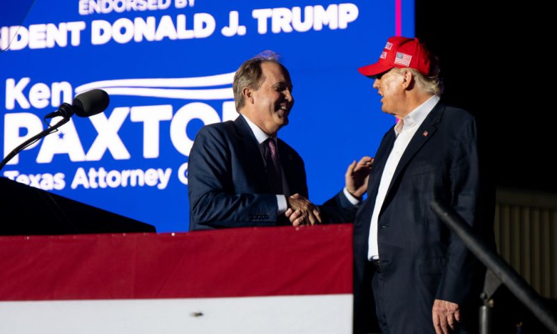 ROBSTOWN, TEXAS - OCTOBER 22: (L-R) Texas Attorney General Ken Paxton greets former U.S. President Donald Trump at the 'Save America' rally on October 22, 2022 in Robstown, Texas. The former president, alongside other Republican nominees and leaders held a rally where they energized supporters and voters ahead of the midterm election. (Photo by Brandon Bell/Getty Images)