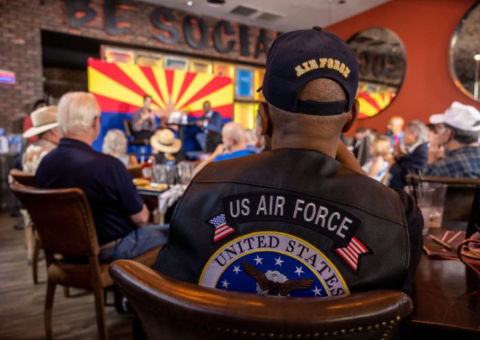 SCOTTSDALE, ARIZONA - NOVEMBER 02: Veterans listen as Republican nominee for Arizona governor Kari Lake speaks at the Social Tap sports bar on November 02, 2022 in Scottsdale, Arizona. The campaign event, part of Lake's "Ask Me Anything Tour" was hosted by Veterans for Kari. (Photo by John Moore/Getty Images)
