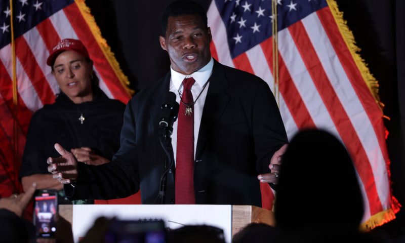 ATLANTA, GEORGIA - NOVEMBER 08: Republican U.S. Senate candidate Herschel Walker speaks to supporters as his wife Julie Blanchard looks on during an election night event on November 8, 2022 in Atlanta, Georgia. Herschel Walker, the University of Georgia Heisman Trophy winner and former NFL running back, faces incumbent Sen. Raphael Warnock (D-GA) in today’s general election. (Photo by Alex Wong/Getty Images)