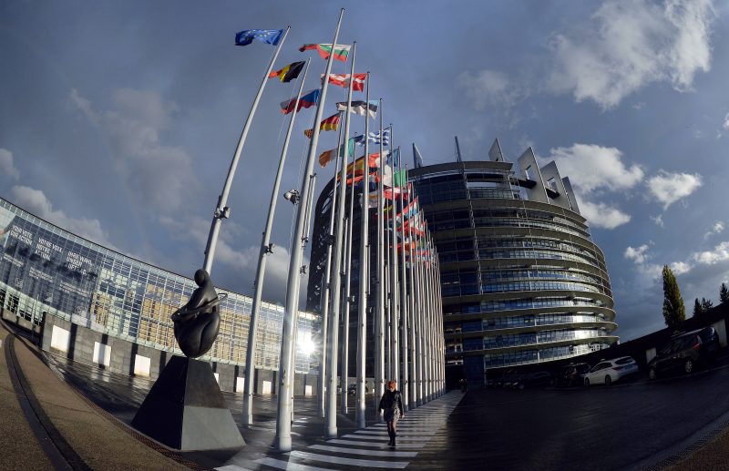 A person walks on October 21, 2014 in front of the European Parliament in Strasbourg, eastern France during a plenary session. AFP PHOTO / PATRICK HERTZOG (Photo credit should read PATRICK HERTZOG/AFP via Getty Images)