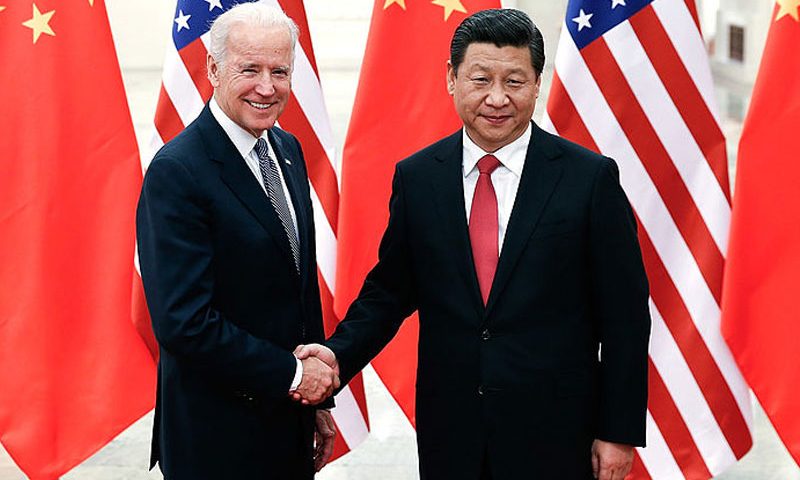 Chinese President Xi Jinping (R) shake hands with U.S Vice President Joe Biden (L) inside the Great Hall of the People on December 4, 2013 in Beijing, China. (Photo by Lintao Zhang/Getty Images)