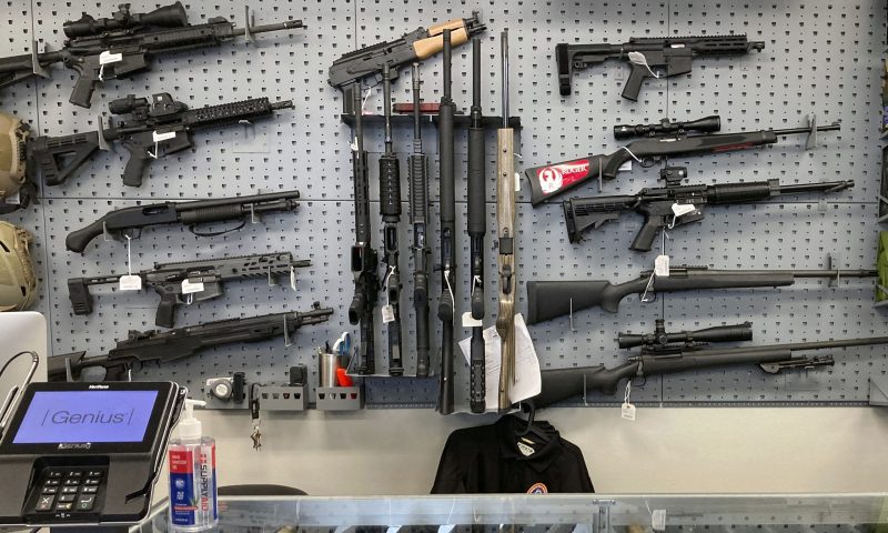 FILE - Firearms are displayed at a gun shop in Salem, Ore., on Feb. 19, 2021. A federal judge in Portland, Ore., ruled Tuesday, Dec. 6, 2022, that a new voter-passed ban on high-capacity gun magazines can go into effect Thursday, Dec. 8, but placed a 30-day hold on a permit-to-purchase requirement after local and state law enforcement agencies said they could not have a permitting system ready in time. (AP Photo/Andrew Selsky, File)