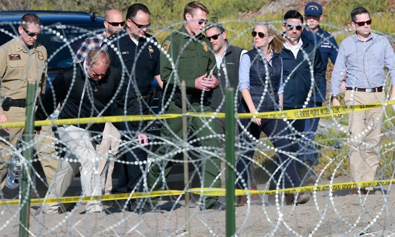 Kirstjen M. Nielsen, Secretary of the Department of Homeland Security, tours the border area with San Diego Section Border Patrol Chief Rodney Scott (L) at Borderfield State Park along the United States-Mexico Border fence in San Ysidro, California on November 20, 2018. - A US federal judge temporarily blocked Donald Trump's administration from denying asylum to people who enter the country illegally, prompting the president to allege Tuesday that the court was biased against him. (Photo by Sandy Huffaker / AFP) (Photo credit should read SANDY HUFFAKER/AFP via Getty Images)