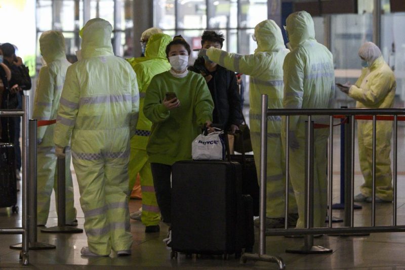 TOPSHOT - Medical workers wearing protective clothing check passengers' travel history at the Shanghai South railway station in Shanghai on February 9, 2020. - The death toll from the novel coronavirus surged past 800 in mainland China on February 9, overtaking global fatalities in the 2002-03 SARS epidemic, even as the World Health Organization said the outbreak appeared to be "stabilising". (Photo by NOEL CELIS / AFP) (Photo by NOEL CELIS/AFP via Getty Images)