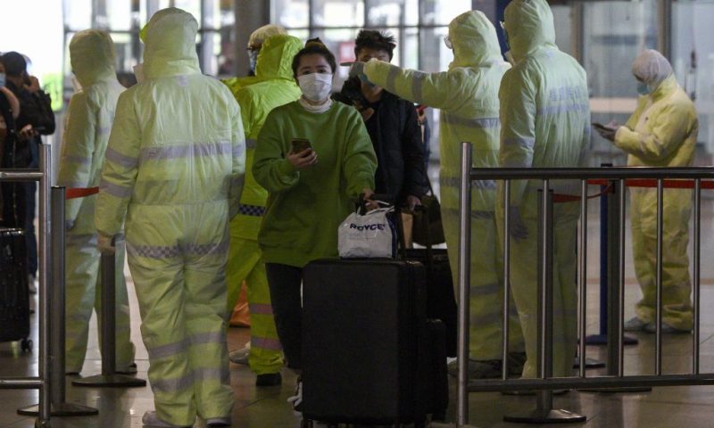 TOPSHOT - Medical workers wearing protective clothing check passengers' travel history at the Shanghai South railway station in Shanghai on February 9, 2020. - The death toll from the novel coronavirus surged past 800 in mainland China on February 9, overtaking global fatalities in the 2002-03 SARS epidemic, even as the World Health Organization said the outbreak appeared to be "stabilising". (Photo by NOEL CELIS / AFP) (Photo by NOEL CELIS/AFP via Getty Images)
