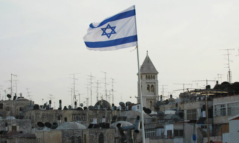 An Israeli flag waves in the wind atop the roof of Wittenberg House an apartment complex in the Muslim quarter of Jerusalem's old city on October 5, 2008. A Jewish family is set to move into their new apartment purchased in the Muslim quarter of the old city of Jerusalem by the ultra-nationalist Jewish association Ateret Cohanim. The association, whose aims include reinforcing the Jewish presence in the old city and east Jerusalem, which were annexed by Israel during the 1967 war, have purchased a number of properties in Muslim quarters of the city since 1978, in which over 900 Jews currently live. AFP PHOTO/YEHUDA RAIZNER (Photo by YEHUDA RAIZNER / AFP) (Photo by YEHUDA RAIZNER/AFP via Getty Images)