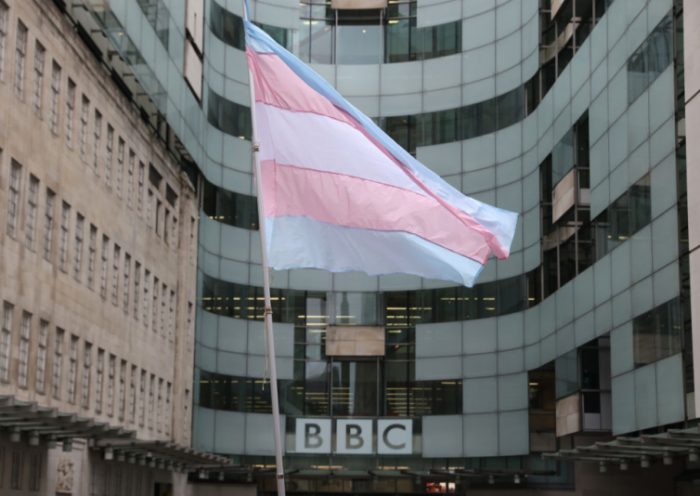 LONDON, ENGLAND - JANUARY 08: A Demonstrator waves a Transgender flag during the Trans Activism UK "British Bigotry Corporation: Platforming Hate Is Not Impartial" protest at BBC Broadcasting House on January 8, 2022 in London, England. Trans Activism UK are protesting at BBC against its perceived anti-trans agenda. (Photo by Hollie Adams/Getty Images)