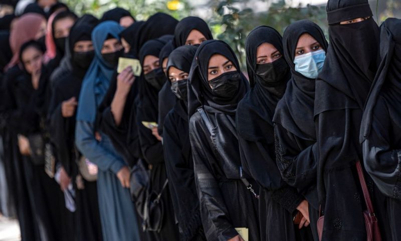 Afghan female students stand in a queue after they arrive for entrance exams at Kabul University in Kabul on October 13, 2022. (Photo by Wakil KOHSAR / AFP) (Photo by WAKIL KOHSAR/AFP via Getty Images)