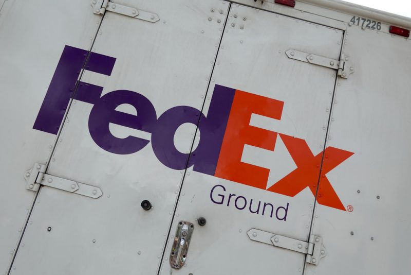 A sign on the side of a FedEx truck on September 16, 2022 in Miami Beach, Florida. Shares of FedEx fell after the company missed estimates on revenue and earnings in its first quarter. (Photo by Joe Raedle/Getty Images)