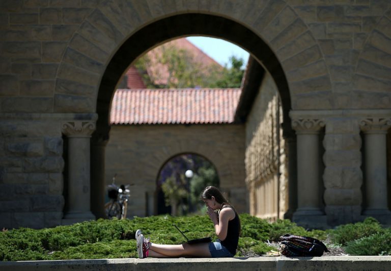 A woman works on a laptop on the Stanford University campus on May 22, 2014 in Stanford, California. According to the Academic Ranking of World Universities by China's Shanghai Jiao Tong University, Stanford University ranked second behind Harvard University as the top universities in the world. UC Berkeley ranked third. (Photo by Justin Sullivan/Getty Images)