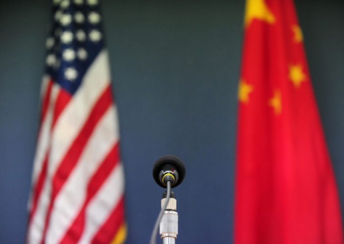 The US and China flags stand behind a microphone awaiting the arrival of US Senator John McCain, who was joined by Senators Lindsey Graham Amy Klobuchar for a press conference at the US Embassy in Beijing on April 9, 2009 during the China stop of the Congressional Delegation's fact-finding Asia-tour. Senator McCain said he urged Chinese officials in talks here to back a strong United Nations response to North Korea's rocket launch, but indicated China had resisted. AFP PHOTO/Frederic J. BROWN (Photo credit should read FREDERIC J. BROWN/AFP via Getty Images)