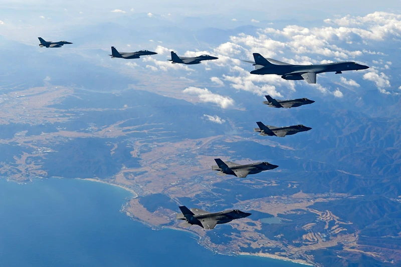 In this handout image provided by South Korean Defense Ministry, U.S. Air Force B-1B bomber (L), South Korea and U.S. fighter jets fly over the Korean Peninsula during the Vigilant air combat exercise (ACE) on December 6, 2017 in Korean Peninsula, South Korea. The largest-scale warplanes and military personnel take part in the annual joint exercise, which was scheduled before the North's latest missile test. North Korea fired a new intercontinental ballistic missile (ICBM) on November 29, believed to have shown capability to reach to the U.S. mainland. (Photo by South Korean Defense Ministry via Getty Images)